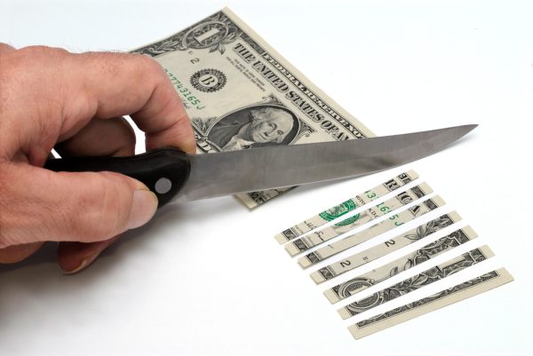 knife cutting $1 bill